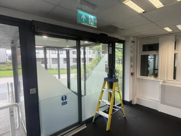 Automatic door installation: a sliding door lobby being fitted