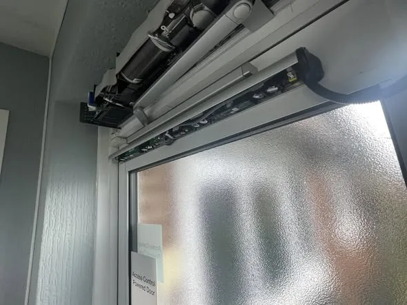 Swing door operator opened up for an automatic door repair